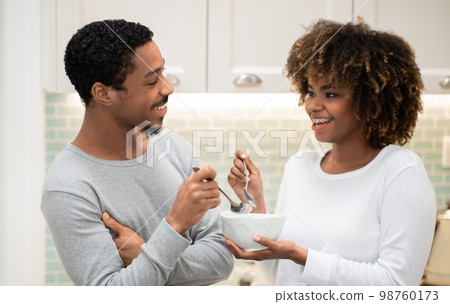 Loving african american couple having breakfast at home Loving african american couple having breakfast at home 98760173