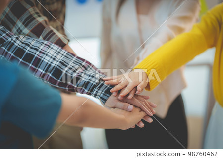 Group of Multiracial people putting their hands working together showing oneness symbol. Group of Multiracial people putting their hands working together showing oneness symbol. 98760462