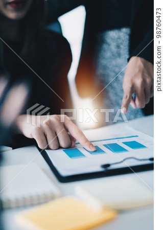 Consult financial concept. Group of Business women pointing at papwework . 98760473