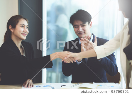 Business people successful negotiation and handshake. celebration partnership and teamwork, business deal concept. 98760501