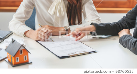 Close up of Business woman pointing and signing agreement for buying house. Bank manager concept. 98760533