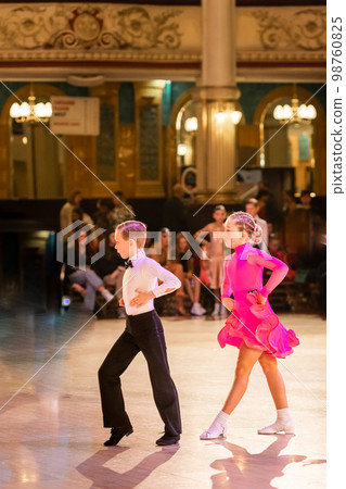 Attractive young couple of children dancing ballroom dance. Girl and boy dancer international dancing. 98760825