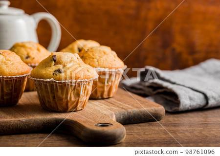 Sweet vanilla muffins  on cutting board. 98761096