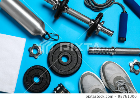 Gym equipment on light blue background, flat lay 98761306