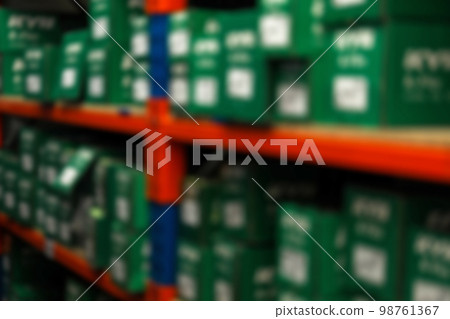 Blurred view of shelving unit with merchandise in modern wholesale shop, closeup Blurred view of shelving unit with merchandise in modern wholesale shop, closeup 98761367