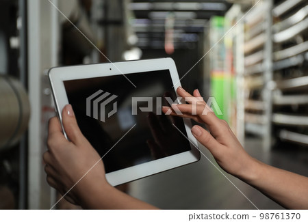 Woman with tablet in wholesale warehouse, closeup. Space for design 98761370
