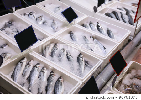 Fresh fish on display with ice at wholesale market 98761375