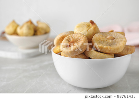 Tasty dried figs on light grey table Tasty dried figs on light grey table 98761433