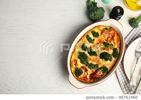 Tasty broccoli casserole in baking dish on white wooden table, flat lay. Space for text Tasty broccoli casserole in baking dish on white wooden table, flat lay. Space for text 98761460