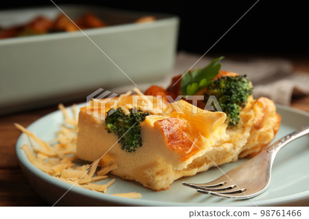 Tasty broccoli casserole with cheese on plate, closeup 98761466