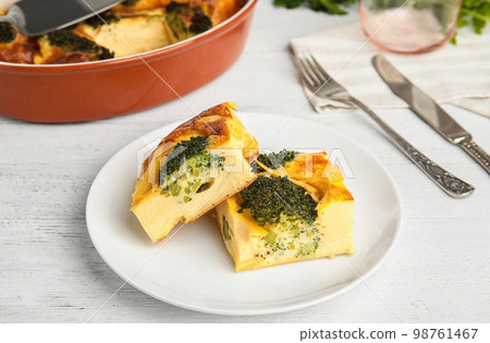 Tasty broccoli casserole served on white wooden table Tasty broccoli casserole served on white wooden table 98761467