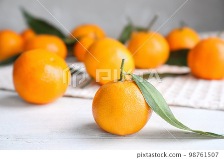 Fresh ripe tangerine on white wooden table Fresh ripe tangerine on white wooden table 98761507