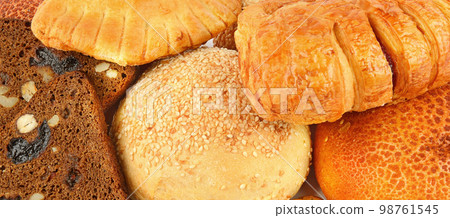 Background of a set of buns and sweet pastries. Wide photo. 98761545