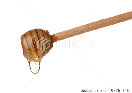 Honey dripping from wooden dipper isolated on white 98761848