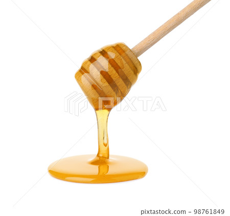 Honey pouring from wooden dipper isolated on white Honey pouring from wooden dipper isolated on white 98761849