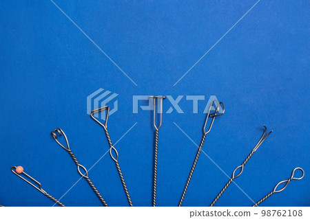 Set of logopedic probes for speech therapy on blue background, flat lay. Space for text Set of logopedic probes for speech therapy on blue background, flat lay. Space for text 98762108