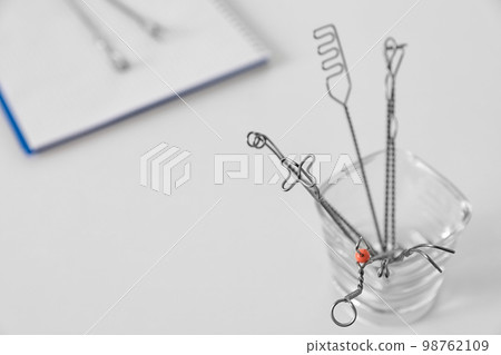 Set of different logopedic probes in holder on light table, space for text. Speech therapist's tools Set of different logopedic probes in holder on light table, space for text. Speech therapist's tools 98762109