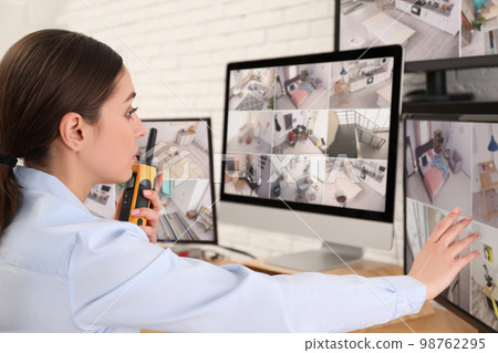 Female security guard with portable transmitter at workplace Female security guard with portable transmitter at workplace 98762295