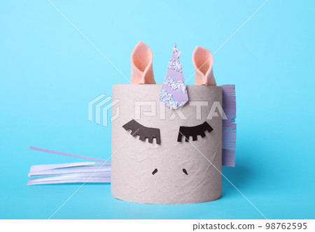 Toy unicorn made of toilet paper roll on light blue background Toy unicorn made of toilet paper roll on light blue background 98762595