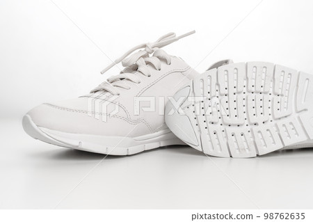 leather sneakers with lacing and perforated sole on a white background. leather sneakers with lacing and perforated sole on a white background. 98762635
