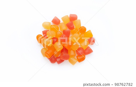Close-up texture of orange and yellow multivitamin gummies in the form of bears on white background. Close-up texture of orange and yellow multivitamin gummies in the form of bears on white background. 98762782