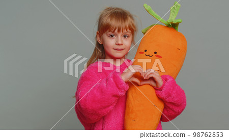 Smiling preteen child girl kid makes heart gesture demonstrates love sign good friendly feelings 98762853