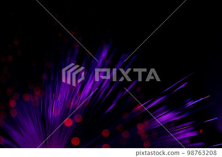 Luminous optical fiber. Fantastic backdrop of illuminated neon fiber optic lines and glowing red bokeh on black. Light guides create circles and light points in the dark. Abstract futuristic concept. Luminous optical fiber. Fantastic backdrop of illuminated neon fiber optic lines and glowing red bokeh on black. Light guides create circles and light points in the dark. Abstract futuristic concept. 98763208