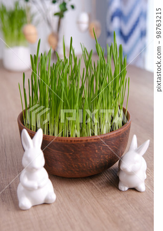Home easter decor. Green oats, decorative rabbits and eggs Home easter decor. Green oats, decorative rabbits and eggs 98763215
