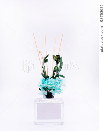 Wooden aroma sticks in a glass flask filled with flavor liquid substance isolated over white background, side view Wooden aroma sticks in a glass flask filled with flavor liquid substance isolated over white background, side view 98763625