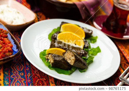 Traditional Turkish Sarma, wrapped vine leaves stuffed with rice Traditional Turkish Sarma, wrapped vine leaves stuffed with rice 98765175