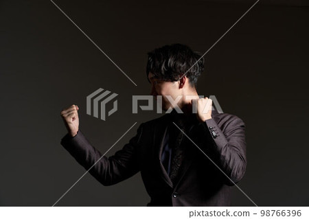 Young business person taking a fighting pose 98766396