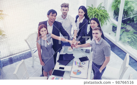 Team Business Partners shaking hands together to Greeting Start up small business in meeting room. Shakehand teamwork partners at modern office handshake together. Business mergers and acquisitions 98766516