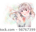 A girl who folds her hands in front of her chest / smile / pastel background 98767399