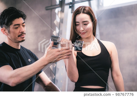 Woman getting personal training at the gym Woman getting personal training at the gym 98767776