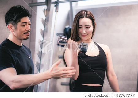 Woman getting personal training at the gym 98767777