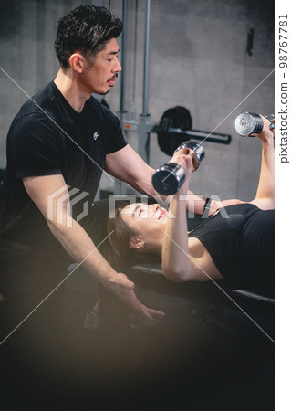 Woman getting personal training at the gym 98767781