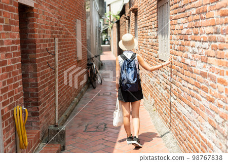 woman walking in the old street at Lukang town woman walking in the old street at Lukang town 98767838