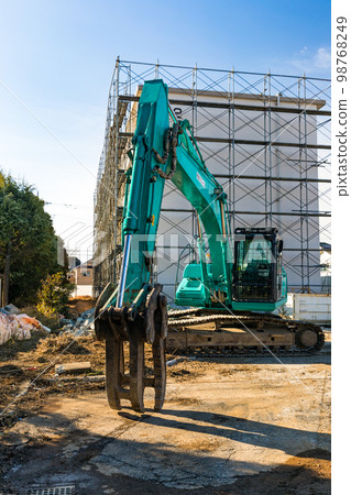 Demolition construction site of housing complex Heavy backhoe Demolition construction site of housing complex Heavy backhoe 98768249