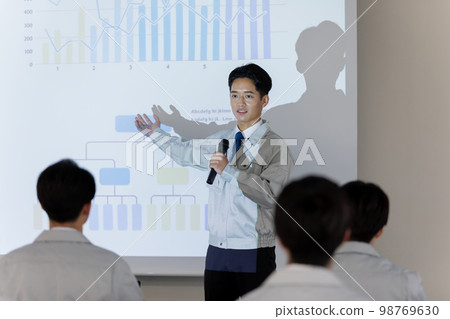 Presenting businessmen Presenting businessmen 98769630