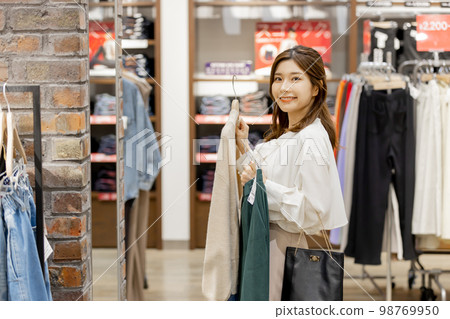 Woman enjoying shopping at an apparel store 98769950