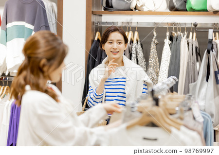Woman enjoying shopping at an apparel store Woman enjoying shopping at an apparel store 98769997