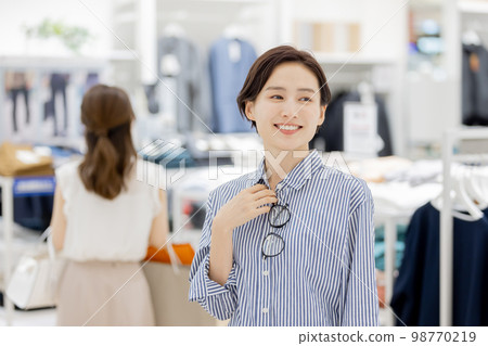 Woman enjoying shopping in a boutique Woman enjoying shopping in a boutique 98770219