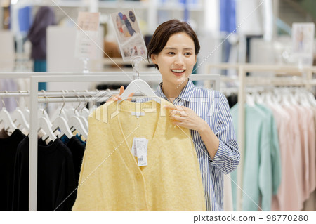 Woman enjoying shopping in a boutique Woman enjoying shopping in a boutique 98770280