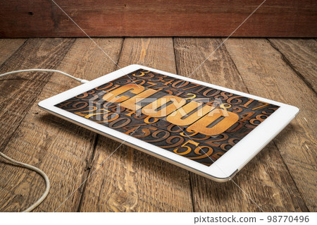cloud computing concept - word in vintage letterpress wood type against numbers on a digital tablet cloud computing concept - word in vintage letterpress wood type against numbers on a digital tablet 98770496