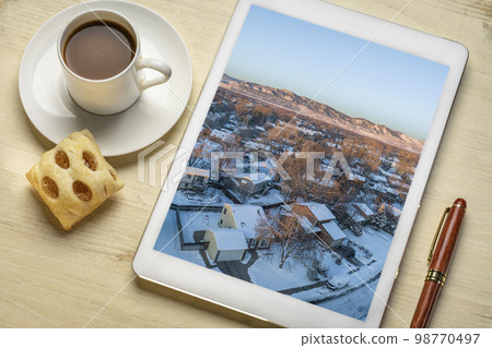 winter sunrise over residential area of Fort Collins and Rocky Mountains in northern Colorado, aerial images on a tablet 98770497