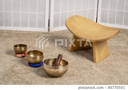 Tibetan singing bowls and meditation, kneeling bench to sit in a natural, balanced and relaxed posture Tibetan singing bowls and meditation, kneeling bench to sit in a natural, balanced and relaxed posture 98770501
