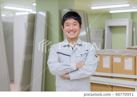 一個穿著工作服的年輕人站在正在建設中的公寓樓的房間裡的肖像 一個穿著工作服的年輕人站在正在建設中的公寓樓的房間裡的肖像 98770951