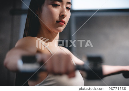 woman doing arm exercises at the gym woman doing arm exercises at the gym 98771588