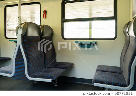 View on railroad track from the window of fast train. Interior view at train's empty window seat window move through countryside Window side view during commute and travel by Train View on railroad track from the window of fast train. Interior view at train's empty window seat window move through countryside Window side view during commute and travel by Train 98771831