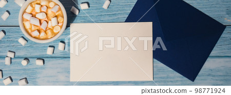 Banner Empty greeting or invitation card mock up blue envelope with white cup of coffee and marshmallows on wooden blue background. Blank paper copy space for your text. Valentines day, Happy fathers Banner Empty greeting or invitation card mock up blue envelope with white cup of coffee and marshmallows on wooden blue background. Blank paper copy space for your text. Valentines day, Happy fathers 98771924